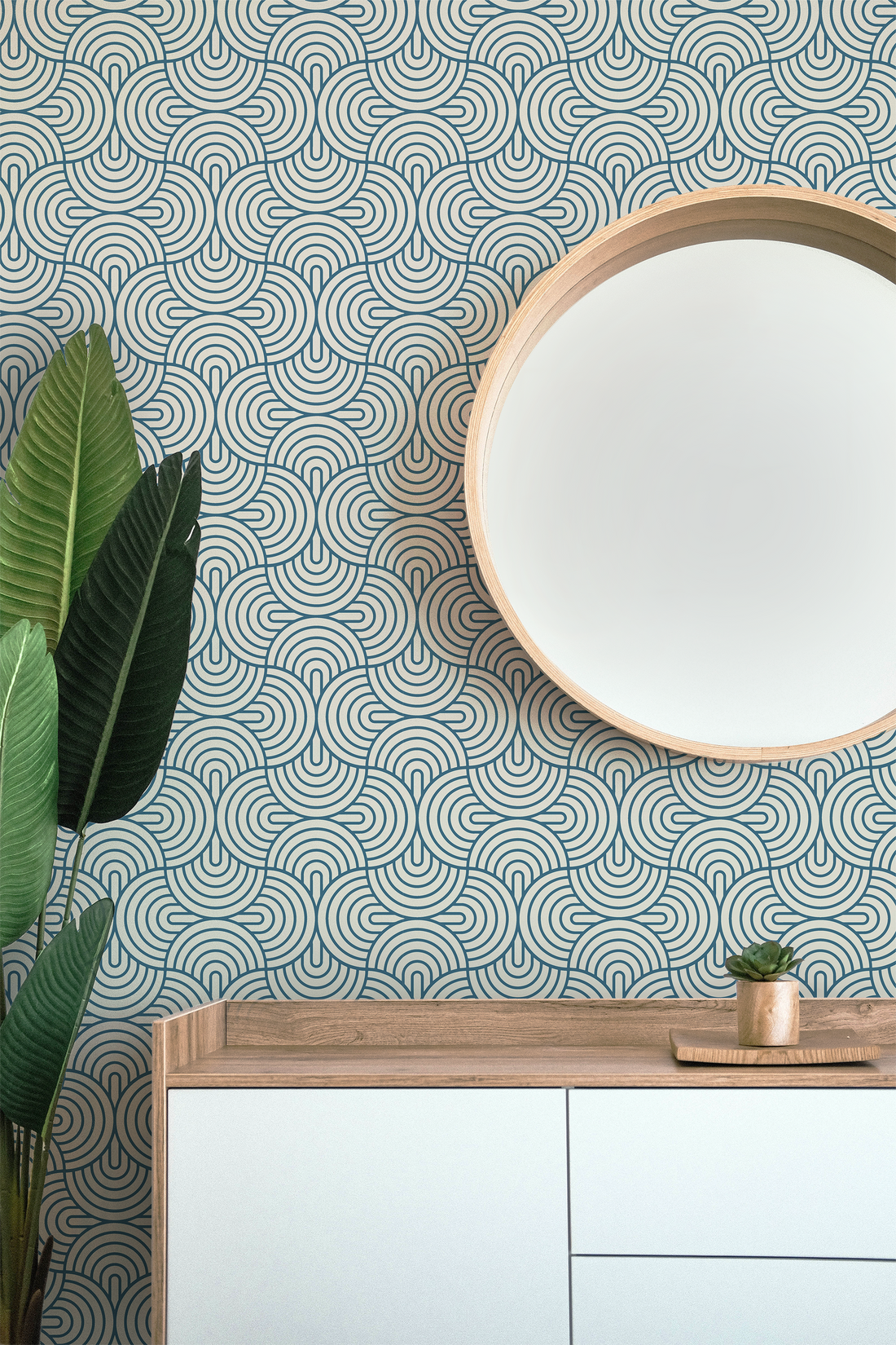 geometric wallpaper in oyster blue with mirror, dresser and plant